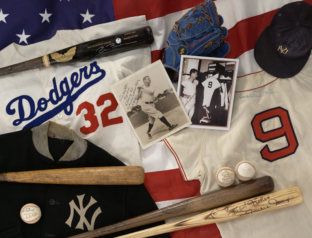 Assortment of baseball memorabilia including jerseys, hats, bats, and vintage photos, featuring items from the dodgers and yankees.